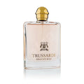 A glass bottle of Trussardi Delicate Rose Eau de Toilette with a gold-colored cap.